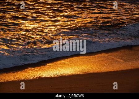 Beautiful beach and shoreline in the warm evening sun, sunset over the Atlantic Ocean near Póvoa de Varzim, Porto district, Portugal Stock Photo