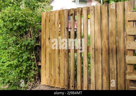 Rustic fence made from old recycled wooden pallets Stock Photo