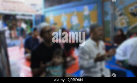 Jakarta, Indonesia - 08 18 2018: abstract defocused background from people who pray during the celebration of orphans' day in the month of Ramadan Stock Photo
