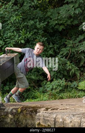 A young boy opening lock gates on the Oxford canal Stock Photo
