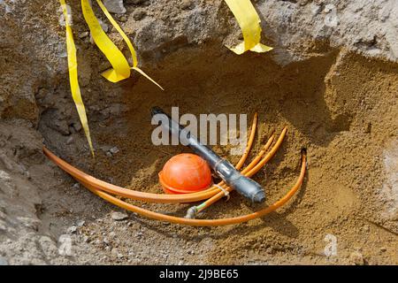 Cable trench with fiber optic cable and power cable Stock Photo
