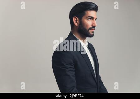 Portrait of an Stylish Latin Man Wearing Suit in studio environment - copy space. High quality photo Stock Photo