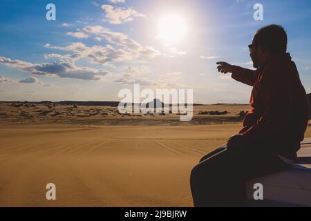 Local Egyptian Man Driver in the White Desert Protected Area on the Adventure 4x4 car Stock Photo