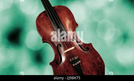 Detail of a Body of violin on green blurred background Stock Photo