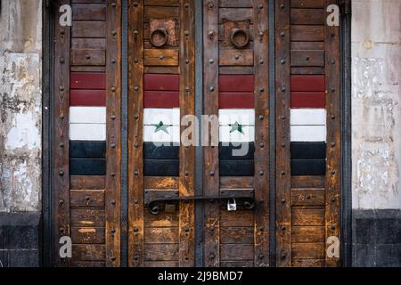 Closed shop door with syrian flag on market in Damascus, Syria Stock Photo