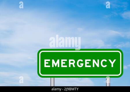 Green color transportation sign with word emergency on blue sky with white cloud background Stock Photo