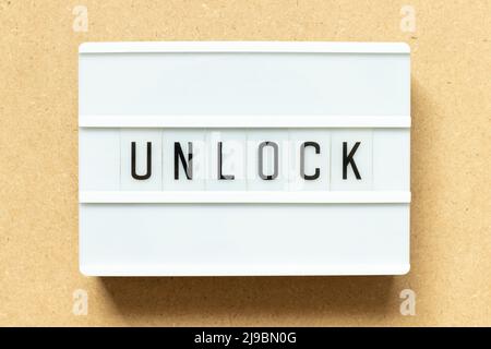 Lightbox with word unlock on wood background Stock Photo