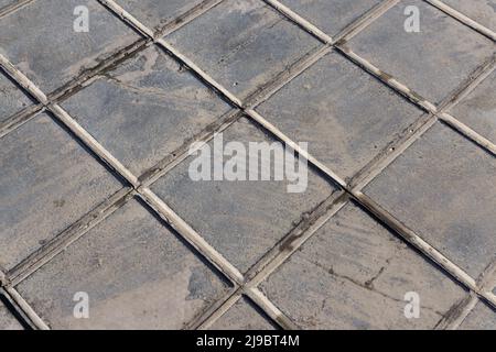 concrete tile for outdoor use Sidewalks, non-slip and wear resistance paving with tile Dirty and broken hydraulic tiles, pattern detail Stock Photo