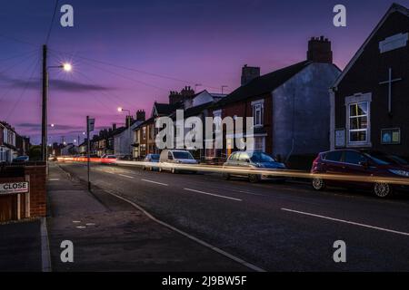 Traffic in a village at sunset. Stock Photo