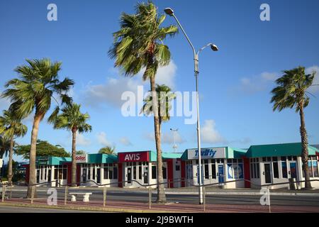 ORANJESTAD, ARUBA - DECEMBER 21, 2020: Car rental offices in the morning outside the Queen Beatrix International Airport in Oranjestad, Aruba Stock Photo