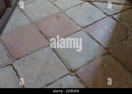 Clay floor tiles, very old probably from the 18th century. Timeworn Stock Photo