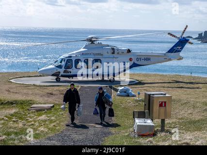 Helicopter is one of the few modes of accessing the remote island of Mykines in the Faroe Islands. Stock Photo
