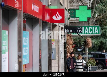 Pedestrians walk past the Spanish multinational commercial bank and financial services of Santander branch in Spain. Stock Photo