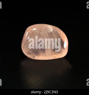 Macro close up colour photograph of Rose Quartz' a semi precious crystal gemstone used in crystal healing therapy Stock Photo