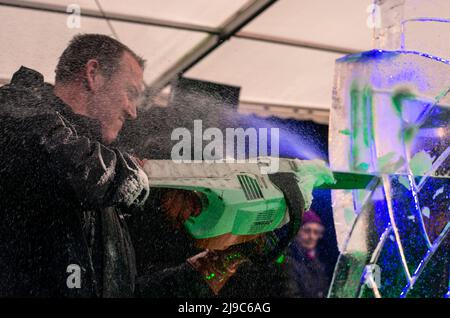 Chief ice sculptor Mat Chaloner working on a Game of Thrones inspired piece at the Festival of Ice and Fire in Barnoldswick in Lancashire. Stock Photo