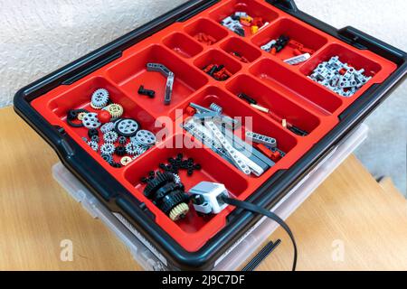 details of the children's plastic constructor are laid out on the beds Stock Photo