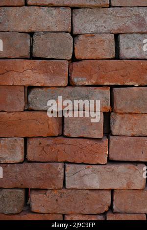 closeup the bunch red bricks keep the row soft focus natural red brown background. Stock Photo