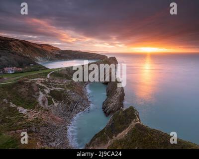 Sunrise over Stair Hole and Lulworth Cove in Dorset. Stock Photo