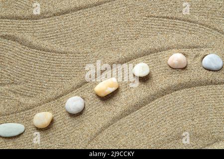 Zen garden with peble stones on brown sand pattern Stock Photo