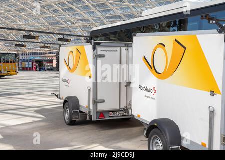 Chur, Switzerland, April 11, 2022 Parking post office trailers standing at the main bus station in the city center Stock Photo