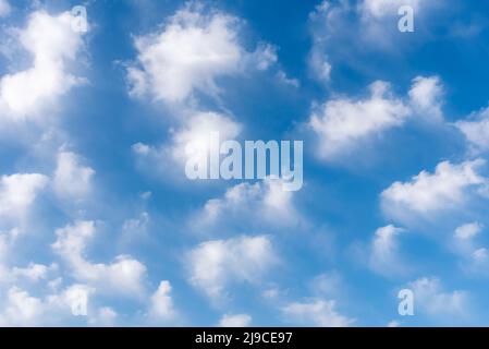 Background of white clouds in a blue sky. Stock Photo