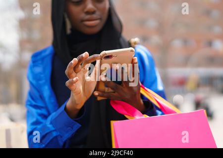 Crop black shopper browsing social media Stock Photo