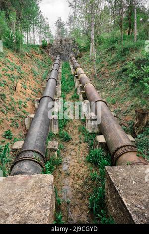 Big metal pipes, low angle view of water transfer pipes at hydroelectric power central Stock Photo