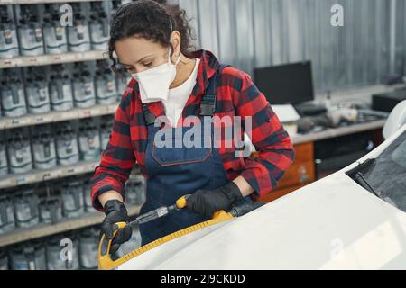 Young female mechanic working in service center Stock Photo