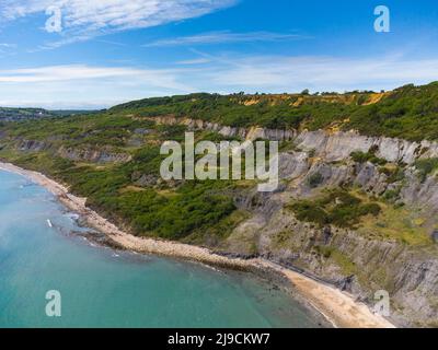 Charmouth, Dorset, UK.  22nd May 2022.  UK Weather.  View from the air of the Black Venn cliffs at Charmouth on the Jurassic Coast of Dorset on an afternoon of scorching hot sunshine. Picture Credit: Graham Hunt/Alamy Live News Stock Photo