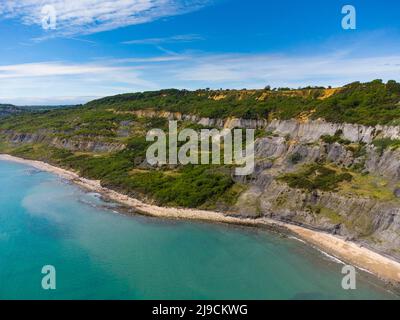 Charmouth, Dorset, UK.  22nd May 2022.  UK Weather.  View from the air of the Black Venn cliffs at Charmouth on the Jurassic Coast of Dorset on an afternoon of scorching hot sunshine. Picture Credit: Graham Hunt/Alamy Live News Stock Photo