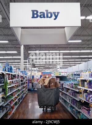 A cart overflowing with empty cardboard boxes rests in a baby section aisle next to partially empty shelves of infant formula on Saturday, May 21, 2022 at a Meijer store in Owensboro, Daviess County, KY, USA. A combination of ongoing supply chain problems, voluntary product recalls and reported panic buying by consumers has resulted in widespread scarcity of infant formula in the United States, leaving state and federal lawmakers scrambling for ways to help manufacturers increase production and get baby formula products on retail shelves faster. (Apex MediaWire Photo by Billy Suratt) Stock Photo