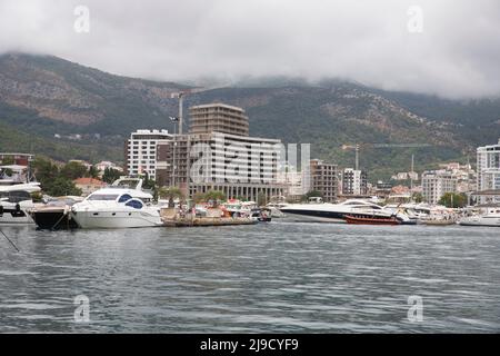 Budva, Montenegro - August 26, 2021: Luxury yachts anchored at harbour in the town of Budva, Montenegro. Luxury travel destination with beatuiful beac Stock Photo