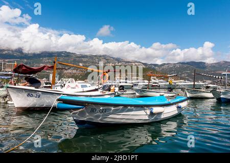 Budva, Montenegro - August 26, 2021: Boats and yachts anchored at harbour in the town of Budva, Montenegro. Luxury travel destination with beatuiful b Stock Photo