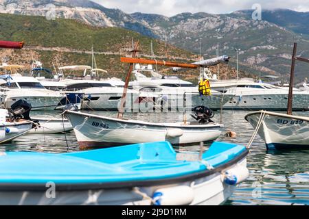 Budva, Montenegro - August 26, 2021: Boats and yachts anchored at harbour in the town of Budva, Montenegro. Luxury travel destination with beatuiful b Stock Photo