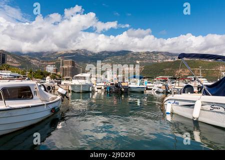 Budva, Montenegro - August 26, 2021: Boats and yachts anchored at harbour in the town of Budva, Montenegro. Luxury travel destination with beatuiful b Stock Photo