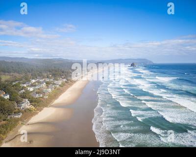 Panoramic shot of the ocean. Light waves crash on the yellow sandy shore. Blue cloudless sky. There are no people in the photo. Travel destinations ad Stock Photo