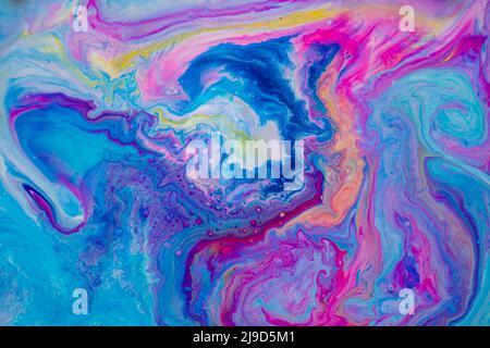 Texture created with acrylic paint on water forming an organic marble effect of various colors, predominantly blue and magenta. Stock Photo