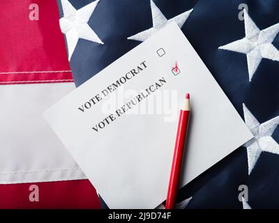 Mark opposite the Republican Party on the ballot in red pencil. The background is the state American flag. US elections, democracy, freedom, right to Stock Photo