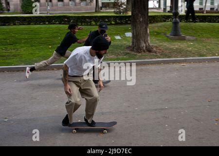 Madrid, Spain. Young men skating in the Paseo de Recoletos, in the city center. Stock Photo