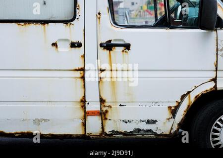 rust and corrosion of the car door. old worn painted metal surface. Stock Photo