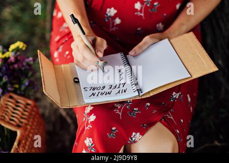 Main life goals, How to Set and Achieve Life Goals. Female hands write in a notebook the inscription My life goals Stock Photo