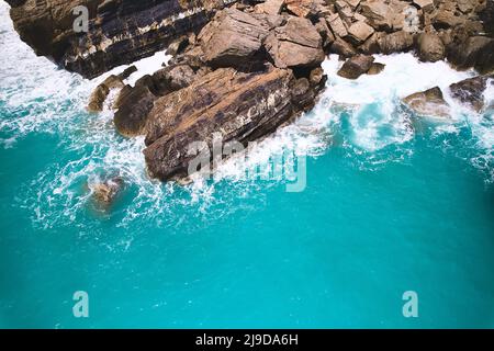 Waves break on rocks Stock Photo