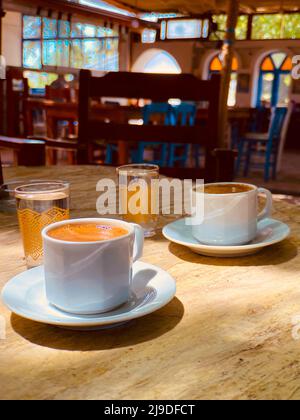 Turkish coffee with almonds, concept idea of almond Turkish coffee drunk in an authentic village coffee equipped with an Aegean theme Stock Photo