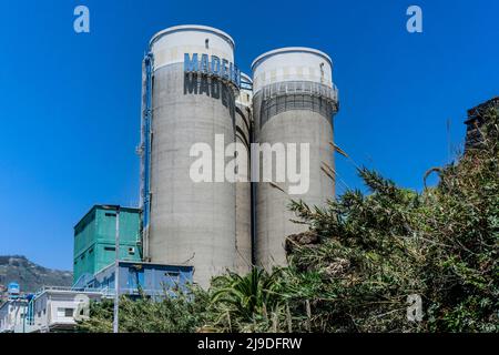 Silos of the Madeira Cement Company near the seafront of San Martinho, Madeira. Stock Photo