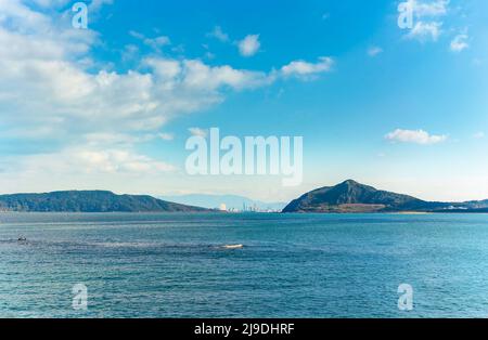 kyushu, fukuoka - december 07 2021: Seascape view of the Fukuoka Tower between the Imazu coast on right and the Nokono Island on left from the Fukuoka Stock Photo