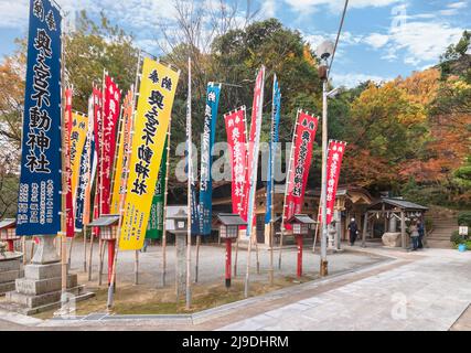kyushu, japan - december 08 2021: Colorful nobori pennants offered by worshippers with the name of Fudo Jinja shrine part of one of the eight Okunomiy Stock Photo