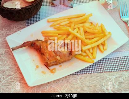 Braised rabbit served with potato garnish Stock Photo