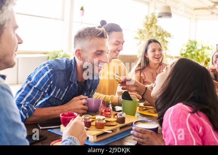 Group of Happy friends having breakfast in the restaurant Stock Photo