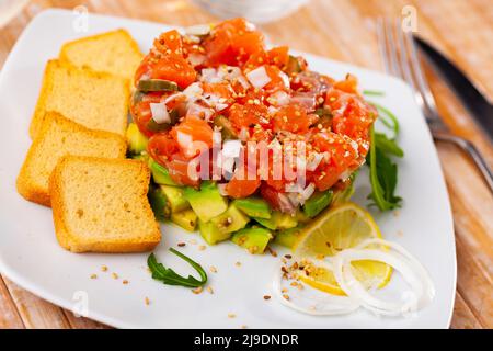 Salmon tartare with avocado and toasted bread Stock Photo