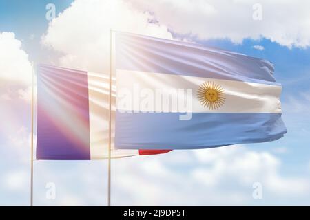 Argentina and France flags waving together on blue cloudy sky, two ...